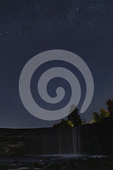 Night scene, Jagala waterfall and starry sky, vertical photo with low light