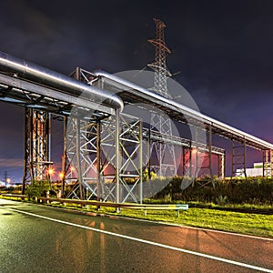 Night scene with large metal constructions for pipeline overpass