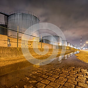 Night scene with large silo at petrochemical production plant, Port of Antwerp