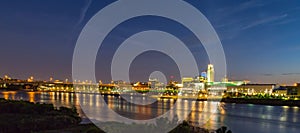 Night scene of Omaha waterfront with light reflections on the r Omaha Nebraska skyline with beautiful sky colors just after sunset