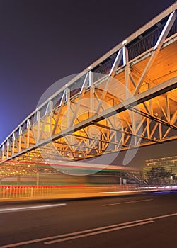 Night scene with pedestrian bridge and traffic in motion blur, Beijing, China