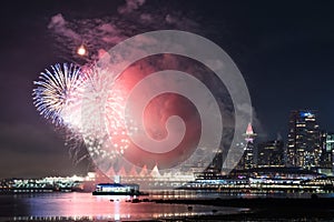 Night scene with red and blue new year fireworks seen from stanley park skyline of vancouver