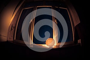 Night scene of stars seen through the window from dark room. Night sky inside dark room. Long exposure shot