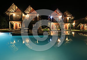 Night scene with swimming pool and houses