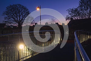 Night scene in town. Small bridge over a rive and city lamp