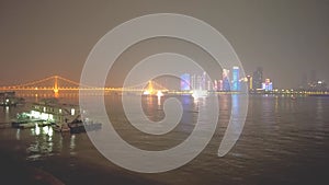 Night scene on the Yangtze River with illuminated high buildings and boats