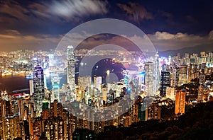 Night scenery of Hong Kong viewed from top of Victoria Peak with city skyline of crowded skyscrapers by Victoria Harbour