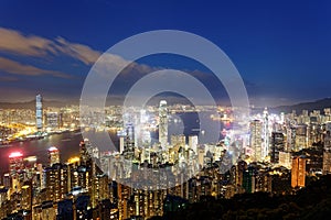 Night scenery of Hong Kong viewed from top of Victoria Peak with city skyline of crowded skyscrapers by Victoria Harbour & Kowloon