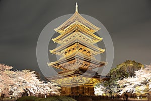 Night scenery of the majestic Five-Story Pagoda surrounded by vibrant Japanese