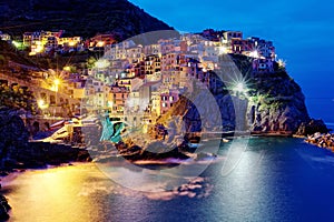 Night scenery of Manarola, an amazing village on vertical cliffs by the rocky coast in Cinque Terre National Park
