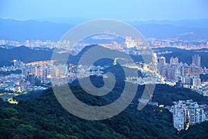 Night scenery of overpopulated Taipei City with view of beautiful lights emitting from buildings photo