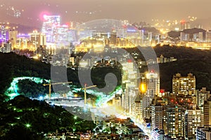 Night scenery of overpopulated Taipei City with view of beautiful lights emitting from buildings photo