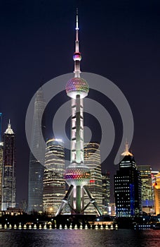 Night Shanghai skyline with Oriental Pearl Tower in the front and reflections in Huangpu river