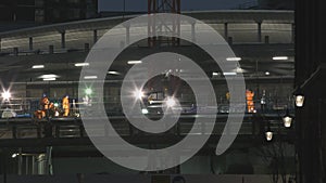 Night shift. Workers at the construction site.