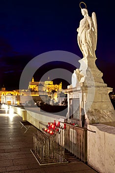 Night shot of Archangel Raphael statue on roman bridge at Cordoba, Andalusia
