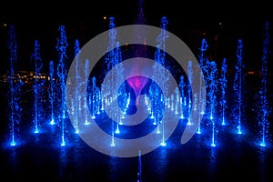 Night shot of blue and purple illuminated fountain, Szeged, Hungary