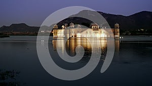 night shot of a floodlit jal mahal palace in jaipur
