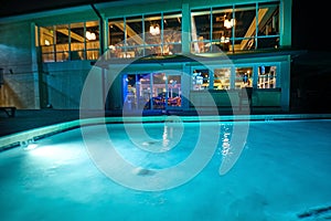 A night shot of a hotel swimming pool.