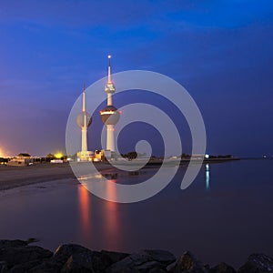 Night shot of the Kuwait towers with the sea and blue sky.