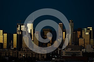 Night shot of Los Angeles downtown with its highrises reflecting the light