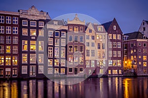 Night shot ofCanal houses on Damrak in Amsterdam