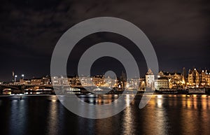 A night shot of Prague from Slavonic Island over Vltava and towards Smichov and JirÃÂ¡sek Bridge - Jiraskuv most photo