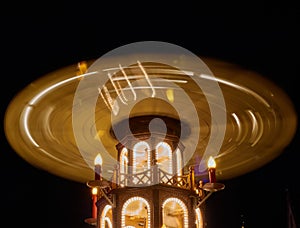 Night shot of the rotating Christmas pyramid on a German Christmas market, intentional motion blurring