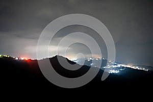 Night shot showing darjeeling village nestled in the middle of himalaya mountains with orange and blue light