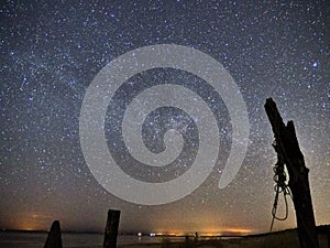 Night sky and milky way stars, Cygnus constellation over sea