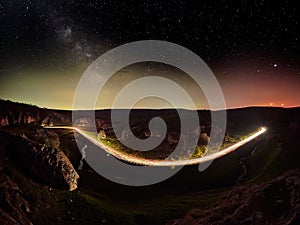 Night sky with milky way and stars, night road illuminated