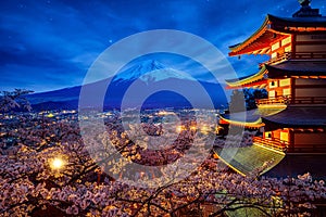 Night sky Mt. Fuji and temple red pagoda in Fujiyoshida with cherry blossom