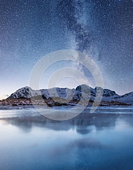 Night sky and reflection on the frozen lake.