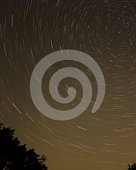 Night sky with spiral star trails around Pole star