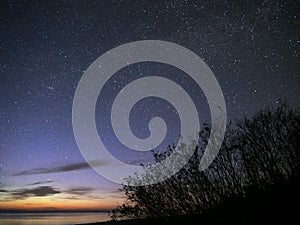 Night sky stars observing Perseus constellation over sea