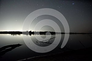 Night sky stars observingn over river in Latvia photo