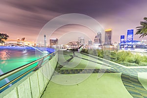 Night skyline of Jacksonville with buildings and square fountain