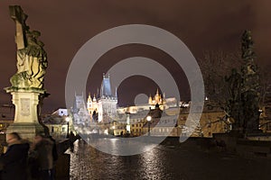 Night colorful snowy Christmas Prague Lesser Town with gothic Castle with Charles Bridge, Czech republic