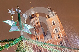 Night snowy view of St. Mary\'s Basilica at the medieval square Rynek Glowny in Krakow, Pola