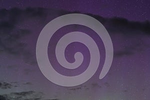 Night starry sky, clouds and northern lights. Astrophotography