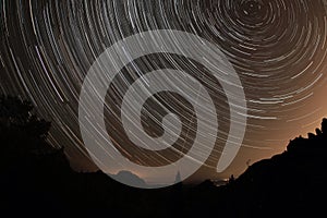 Night starry sky over the tops of rocks in the forest, Stolby Nature Reserve Russia