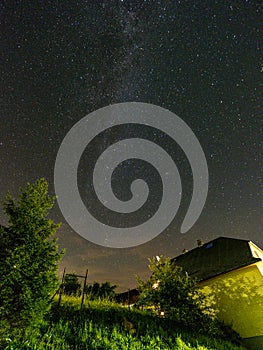 Night stars and milky way galaxy above slovakian village