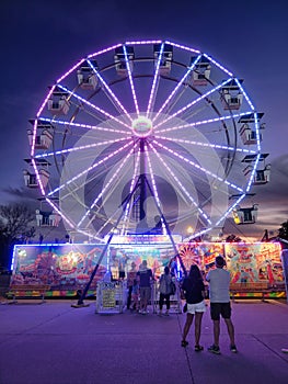 A night at the state fair. Carnival, state fair, ferris wheel,  rides, sunset, evening, entertainment, fun,