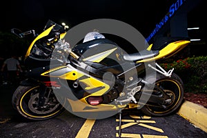 Night stock image of a yellow and black Suzuki gsxr sport bike motorcycle