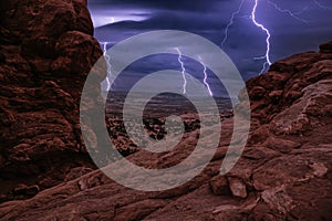 Night Storm with thunderbolts in South Window, Arches National Park, Utah, USA