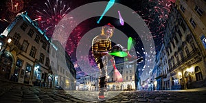 Night street circus performance whit clown, juggler. Festival city background. fireworks and Celebration atmosphere. Wide engle