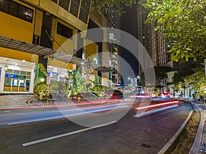 Night street scene from Eastwood neighborhood in Manila photo