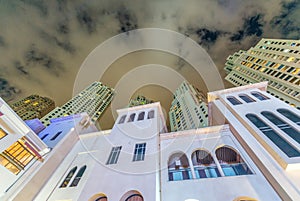 Night street view of old and modern Dubai Marina buildings - UAE