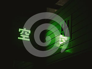 The night streets in Japan. The green neon kanji \