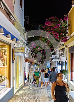 Night streets with many open souvenir shops at Thira town