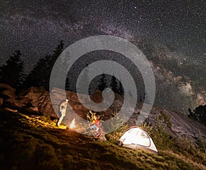 Night summer camping in the mountains under night starry sky